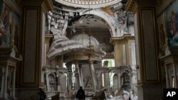 Church personnel inspect damage inside the Transfiguration Cathedral in Odesa, Ukraine, July 23, 2023, following Russian missile attacks.