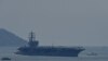 The USS Ronald Reagan, a US Navy Nimitz-class nuclear-powered aircraft carrier, pulls into port in Danang on June 25, 2023. 