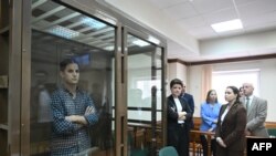 US journalist Evan Gershkovich stands inside a defendants' cage before a hearing to consider an appeal on his arrest at the Moscow City Court in Moscow, Apr. 18, 2023. 