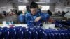 中国河北武强县的一名乐器厂工人在生产线上。（2023年2月23日）