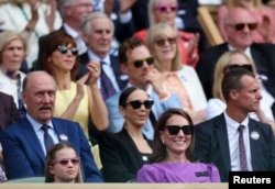 Britain's Catherine, Princess of Wales and Princess Charlotte are seen in the royal box during the men's singles final between Spain's Carlos Alcaraz and Serbia's Novak Djokovic, Wimbledon, July 14, 2024.