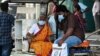 People wear face masks as they arrive at a government hospital in Chennai, India, on April 1, 2023, amid a rise in COVID-19 cases in India. 