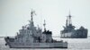 Philippine coast guard patrol vessel BRP Malapascua, left, goes near the Philippine navy ship BRP Sierra Madre at the Second Thomas Shoal, at the South China Sea, April 23, 2023.