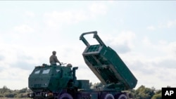 A High-Mobility Artillery Rocket System (HIMARS ) in operation during military exercises at Spilve Airport in Riga, Latvia, Sept. 26, 2022. 