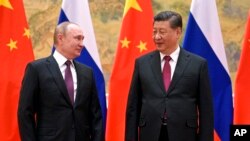 FILE - Chinese President Xi Jinping and Russian President Vladimir Putin meeting in Beijing, Feb. 4, 2022.