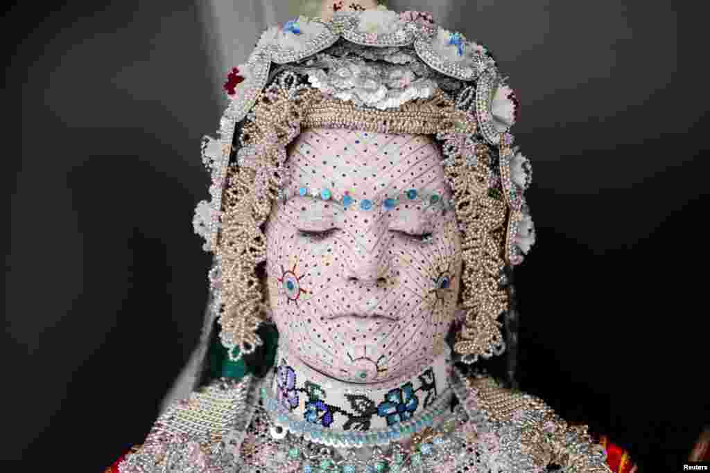 Melissa Guerrero, a U.S. citizen of Mexican origin, wears traditional wedding makeup and a traditional costume during her wedding ceremony in the village of Donje Ljubinje, near Prizren, Kosovo.