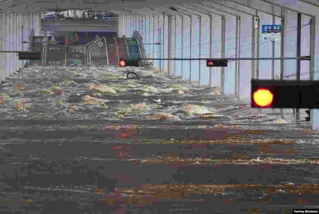 A bridge is submerged by torrential rain from the previous day, on the Han River in Seoul, South Korea.