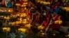 Hindu women light oil lamps at the Banganga pond as they celebrate Dev Diwali festival in Mumbai, India, 