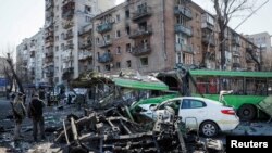 A views shows a building and vehicles destroyed by shelling as Russia's attack on Ukraine continues, in Kyiv, Ukraine, March 14, 2022.