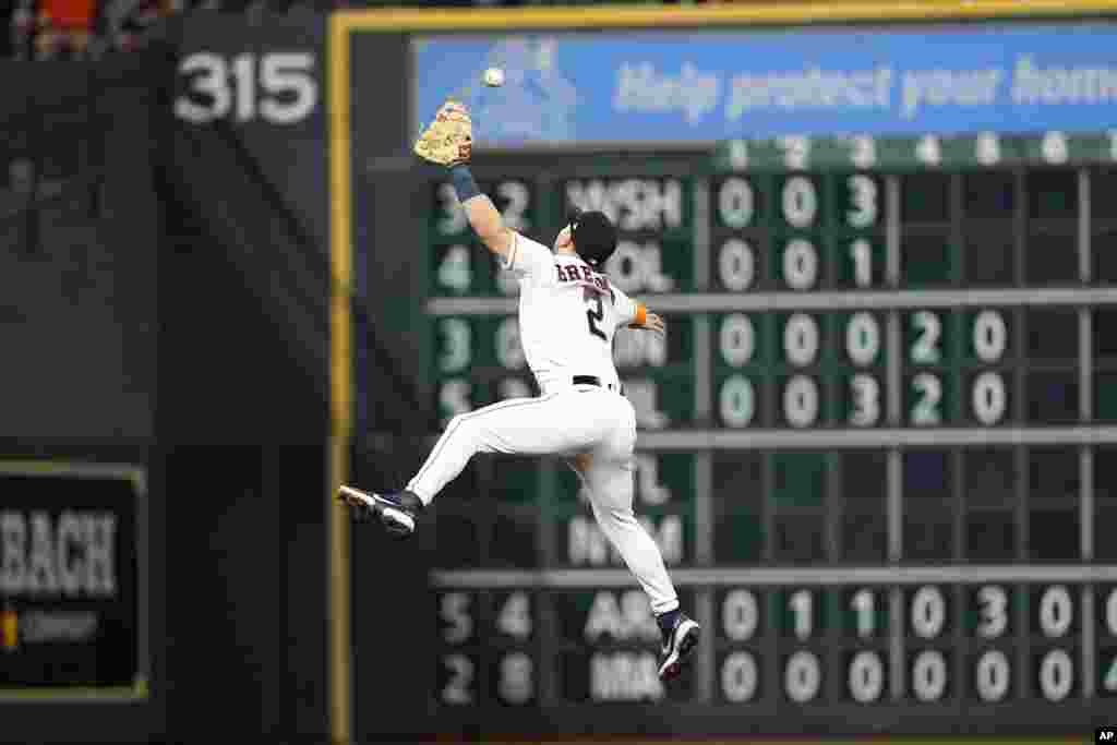 Houston Astros third baseman Alex Bregman tries to catch a single by Seattle Mariners&#39; Adam Frazier during the sixth inning of a baseball game, May 3, 2022, in Houston, Texas.