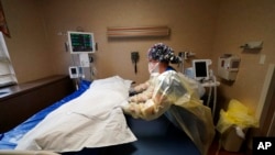 Medical staff move a COVID-19 patient who died onto a gurney to hand off to a funeral home van, at the Willis-Knighton Medical Center in Shreveport, La., Aug. 18, 2021.