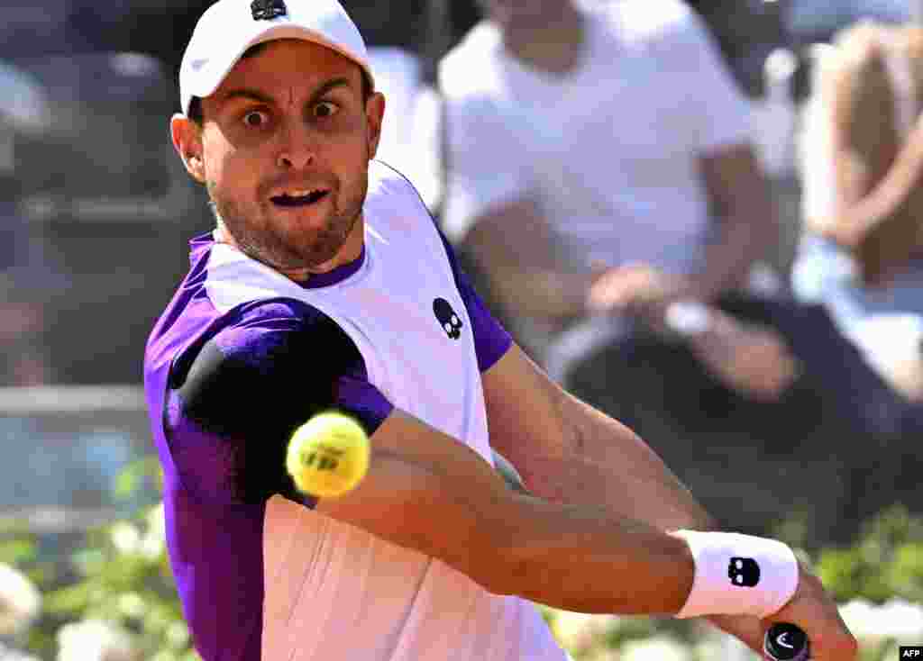 Russia's Aslan Karatsev returns to Serbia's Novak Djokovic during their first round match at the ATP Rome Open tennis tournament at Foro Italico in Rome. 