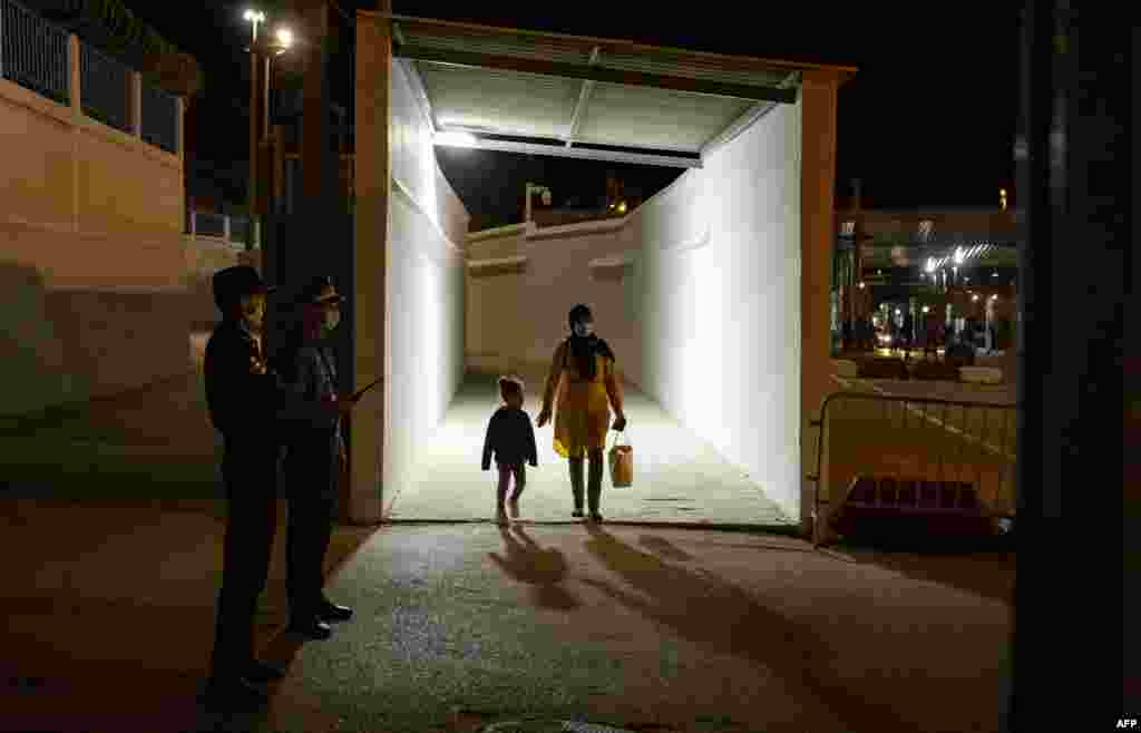 People arrive in Fnideq, Morocco, after crossing in from the Spanish enclave of Ceuta as the land border between Morocco and Spain reopens after two years.&nbsp;