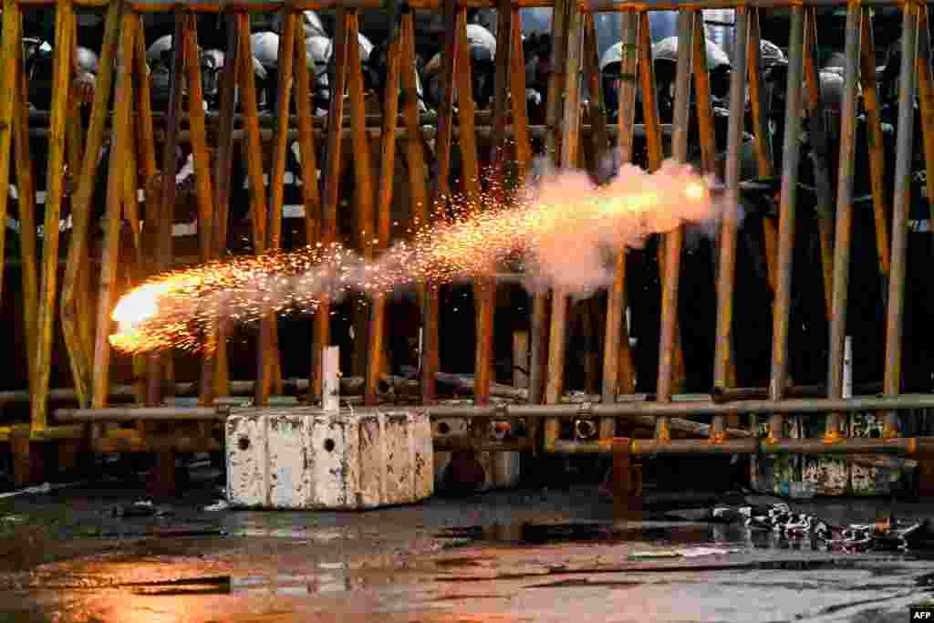 Police fire tear gas shells to disperse students taking part in an anti-government protest demanding the resignation of Sri Lanka&#39;s President Gotabaya Rajapaksa over the country&#39;s crippling economic crisis, in Colombo.