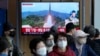 FILE - A TV screen shows a file image of North Korea's missile launch during a news program at the Seoul Railway Station in Seoul, South Korea on Oct. 14, 2022. 