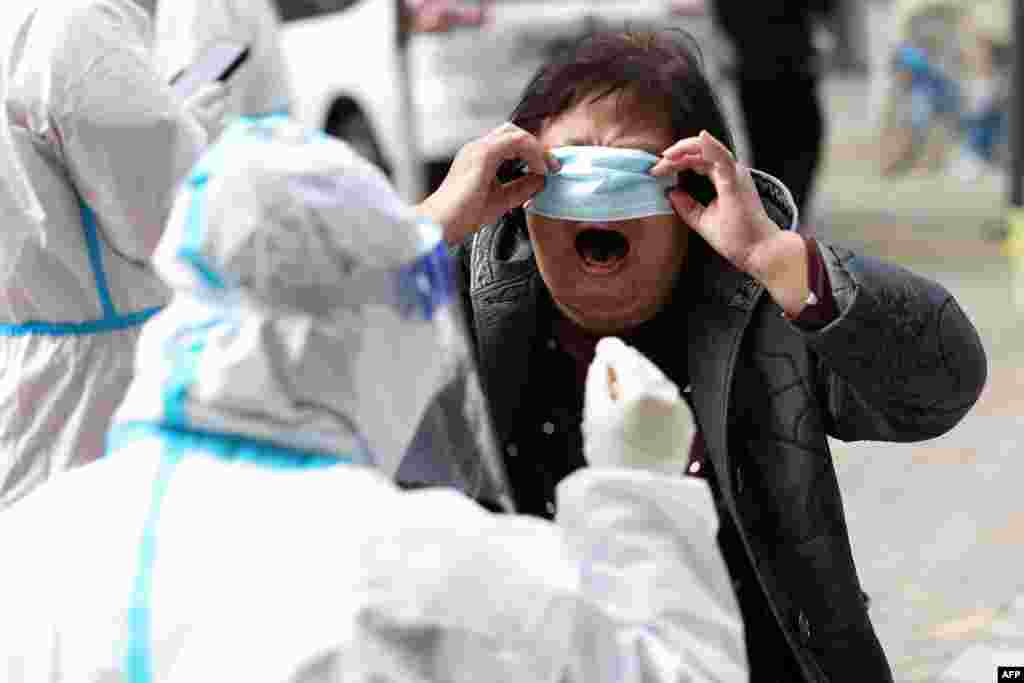 A resident undergoes a nucleic acid test for the COVID-19 in Shenyang, in China&#39;s northeastern Liaoning province.