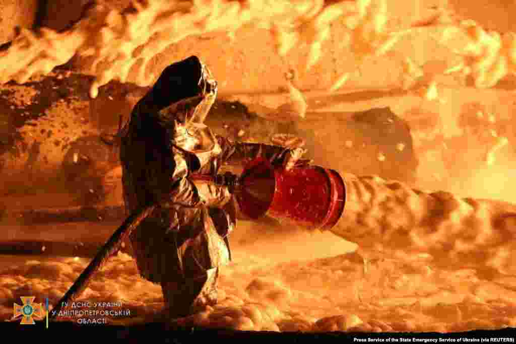 A firefighter works at the site of burning fuel storage facilities damaged by an airstrike in the Dnipropetrovsk region of Ukraine amid Russia&#39;s invasion of Ukraine.