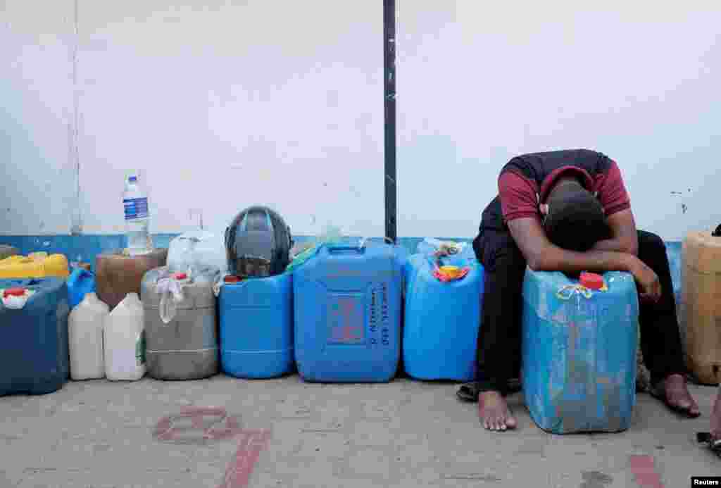 A man rests while waiting in a line to buy diesel near a Ceylon Petroleum Corporation fuel station, amid the country&#39;s economic crisis in Colombo, Sri Lanka.