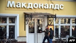 People enter a McDonald's restaurant in Moscow on March 9, 2022. 
