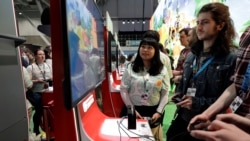 Visitors to the Pax East conference play the new Nintendo Switch video game Animal Crossing, Thursday, Feb. 27, 2020, in Boston. (AP Photo/Steven Senne)