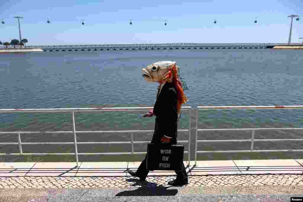 An activist with Ocean Rebellion walks to take part in a protest outside theU.N. Ocean Conference against what they describe as a &quot;war on fish&quot;, in Lisbon, Portugal.
