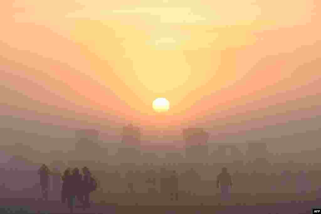 Revelers celebrate the Summer Solstice as the sun rises at Stonehenge, near Amesbury, in Wiltshire, England, in a festival dating back thousands of years to mark the longest day of the year when the sun is at its maximum elevation.