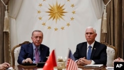 Vice President Mike Pence meets with Turkish President Recep Tayyip Erdogan at the Presidential Palace for talks on the Kurds and Syria, Thursday, Oct. 17, 2019, in Ankara, Turkey. (AP Photo/Jacquelyn Martin)