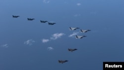 Japan Air Self-Defense Force's F-15 and F-2 fighters hold a joint military drill with U.S. Marine Aircraft Group's F-35B fighters off Japan's southernmost main island of Kyushu, Japan