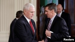 Vice President Mike Pence greets National Security Advisor Michael Flynn before Japanese Prime Minister Shinzo Abe and U.S. President Donald Trump arrive for their joint news conference at the White House in Washington, Feb. 10, 2017.
