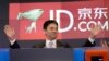 Qiangdong Liu, CEO of JD.com, raises his armsprior to the opening of the Nasdaq market, Thursday, May 22, 2014 in New York.