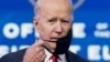 U.S. President-elect Joe Biden adjusts his face mask as he speaks about his plan to administer coronavirus disease vaccines to the U.S. population, during a news conference at Biden's transition headquarters in Wilmington, Del., Jan. 15, 2021.