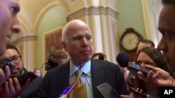 Sen. John McCain, R-Ariz., speaks to reporters following the weekly Republican policy luncheon on Capitol Hill in Washington, Oct. 31, 2017