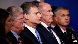 From left, White House press secretary Sarah Sanders, national security adviser John Bolton, FBI Director Christopher Wray, Director of National Intelligence Dan Coats and National Security Agency Director Gen. Paul Nakasone listen during the daily press briefing at the White House, Aug. 2, 2018.