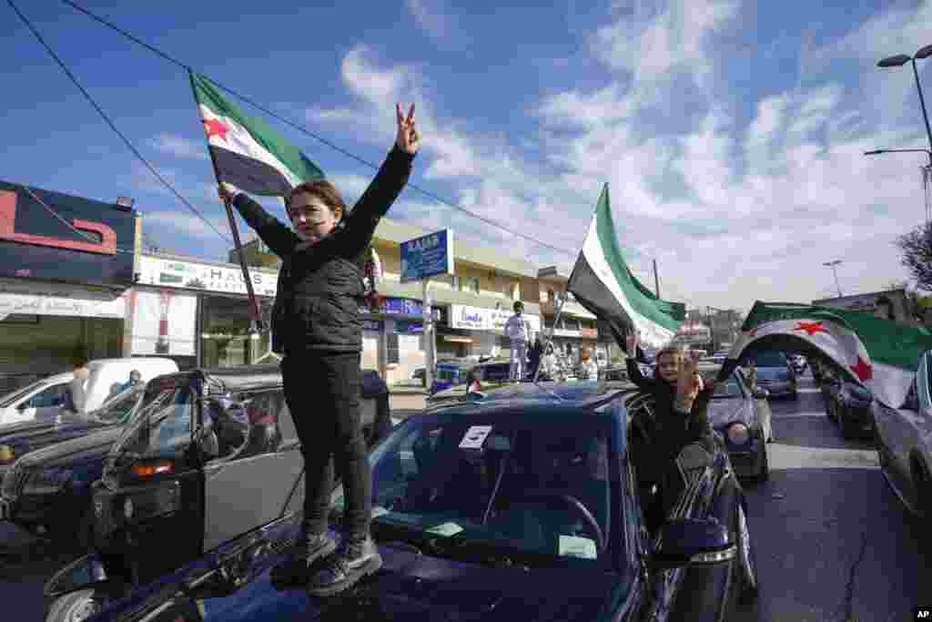 Syrians celebrate the fall of Bashar Assad's government in the town of Bar Elias, Lebanon, near the border with Syria, Dec. 8, 2024. 
