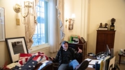 a supporter of Donald Trump sits inside the office of US Speaker of the House Nancy Pelosi