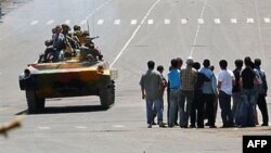 载着吉尔吉斯士兵的装甲车行驶在奥什大街上