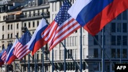 US and Russian flags fly on the Mont-Blanc bridge on the eve of a US-Russia summit, on June 15, 2021 in Geneva. (Photo by SEBASTIEN BOZON / AFP)