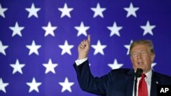 FILE - President Donald Trump speaks at a fundraiser in Fargo, N.D., Sept. 7, 2018. Trump is assailing investigative journalist Bob Woodward's book about him and his White House as 'just another assault against me, in a barrage of assaults.'
