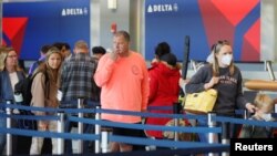 FILE PHOTO: Travellers at Logan Airport after mask mandate struck down in Boston