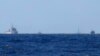 2014年7月15日南中国海地区，从远处可见护卫海洋石油981钻井平台的中国船只。