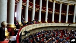 FILE - Visitors, top, and parliament members attend the questions to the government session at the National Assembly in Paris, Dec. 4, 2018