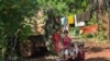 FILE - This picture taken on June 3, 2021 shows people taking refuge in a jungle area in Demoso, Kayah state. (Photo by STR / AFP)