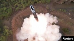 FILE PHOTO: A view of a test launch of a new solid-fuel intercontinental ballistic missile (ICBM) Hwasong-18