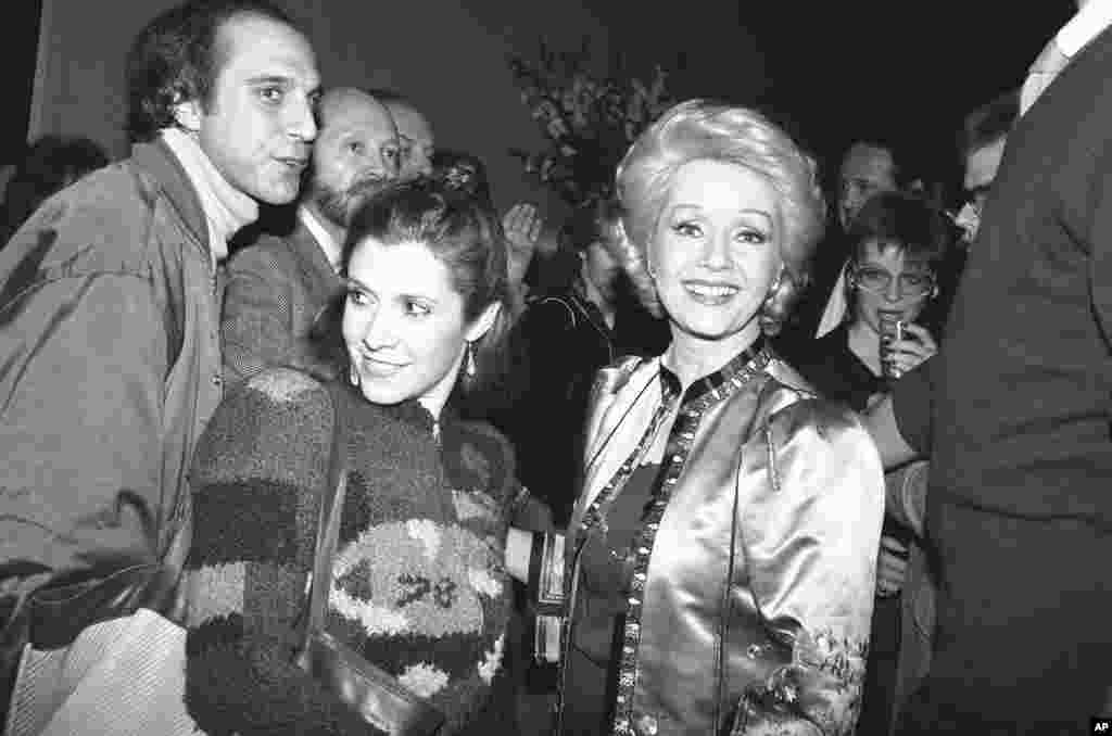  Debbie Reynolds and daughter Carrie Fisher smile for the crowd of well wishers at a party in New York, Feb. 17, 1983, marking Reynolds' return to Broadway. Reynolds steps into "Woman of the Year," which previously starred Lauren Bacall and Raquel Welch. 