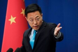 FILE - In this file photo taken Monday, Feb. 24, 2020, Chinese Foreign Ministry new spokesman Zhao Lijian gestures as he speaks during a daily briefing at the Ministry of Foreign Affairs office in Beijing. From Asia to Africa, London to Berlin,…