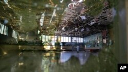 Damage of the Dubai City wedding hall is seen after an explosion in Kabul, Afghanistan, Sunday, Aug. 18, 2019. A suicide-bomb blast ripped through a wedding party on a busy Saturday night. (AP Photo/Rafiq Maqbool)