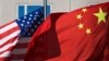 U.S. flag and China's flag flutter in winds at a hotel in Beijing, Sept. 5, 2012.
