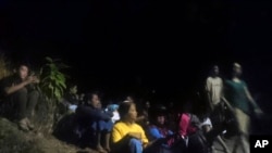 Residents wait as they evacuate to higher ground following an earthquake in Lombok, Indonesia, Aug. 5, 2018. 