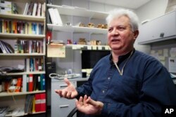 FILE - Amr Al Azm, a professor of Middle East History and Anthropology at Shawnee State University, speaks at his office in Portsmouth, Ohio, April 25, 2019.