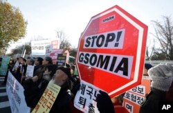 ea and Japan, in front of the Defense South Korean protesters stage a rally to oppose the General Security of Military Information Agreement (GSOMIA) between South KorMinistry in Seoul, South Korea.